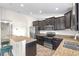 Well-equipped kitchen with stainless steel appliances, dark cabinets, granite counters, and breakfast bar for casual dining at 2404 Dovesong Trace Dr, Ruskin, FL 33570