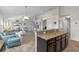 Open concept kitchen and living room, with tile floors and neutral walls at 2404 Dovesong Trace Dr, Ruskin, FL 33570