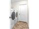 Functional laundry room featuring a stacked washer and dryer set and easy access with a door at 2404 Dovesong Trace Dr, Ruskin, FL 33570