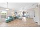 Bright living room with tile flooring, ceiling fan, and sliding glass doors leading to the outdoor patio at 2404 Dovesong Trace Dr, Ruskin, FL 33570