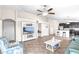 Open-concept living space with a tv, tile flooring, and seamless flow to the kitchen with breakfast bar and stool seating at 2404 Dovesong Trace Dr, Ruskin, FL 33570