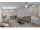 Inviting living room featuring tile floors, a ceiling fan, and neutral paint, creating a bright and airy atmosphere at 2404 Dovesong Trace Dr, Ruskin, FL 33570