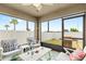 Enclosed patio with stylish seating area and outdoor grill with backyard views at 2404 Dovesong Trace Dr, Ruskin, FL 33570