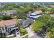 Birds-eye view of a property nestled among lush trees, showcasing the home's setting with a distant water view at 2607 S Bryant Cir, Tampa, FL 33629