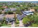 Aerial view of the property, surrounded by lush greenery and neighboring houses with a glimpse of the ocean at 2607 S Bryant Cir, Tampa, FL 33629