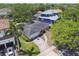 Aerial view of a charming single-story home with a lush yard, long driveway, and surrounded by trees at 2607 S Bryant Cir, Tampa, FL 33629