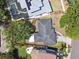Aerial shot of the property featuring a house with a dark roof and lush surrounding trees, as defined by a red perimeter at 2607 S Bryant Cir, Tampa, FL 33629