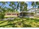 Spacious backyard featuring a large, screened-in lanai and ample green space, perfect for outdoor activities at 2607 S Bryant Cir, Tampa, FL 33629