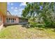Backyard featuring a screened-in lanai, well-maintained lawn, mature trees, and ample space for outdoor activities at 2607 S Bryant Cir, Tampa, FL 33629