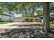 Charming single-story home with a manicured lawn, mature trees and inviting curb appeal on a sunny day at 2607 S Bryant Cir, Tampa, FL 33629