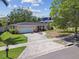 Charming single-story home with a well-maintained lawn, driveway, and attached two-car garage, and a well-maintained yard at 2607 S Bryant Cir, Tampa, FL 33629