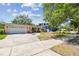 A charming single-story house with a two car garage and well kept lawn, accented by a curved walkway at 2607 S Bryant Cir, Tampa, FL 33629