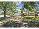 Charming single-story home featuring a manicured lawn, mature trees, and a welcoming front porch with a single-car garage at 2607 S Bryant Cir, Tampa, FL 33629