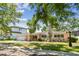 Charming single-story home with a well-maintained lawn and mature trees, set against a blue sky at 2607 S Bryant Cir, Tampa, FL 33629