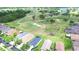 This is an aerial view of a community of single Gathering homes that backs onto a green and beautifully maintained golf course at 2816 Graphite Ct, Valrico, FL 33594