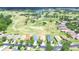 Scenic aerial view of a golf course community with homes surrounding a picturesque lake at 2816 Graphite Ct, Valrico, FL 33594
