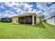Spacious backyard features a screened-in lanai for enjoying the outdoors with view of well-manicured lawn at 2816 Graphite Ct, Valrico, FL 33594
