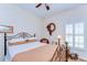 Bright bedroom with a wrought iron bed frame, a window with shutters, and a ceiling fan at 2816 Graphite Ct, Valrico, FL 33594