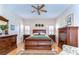 Spacious bedroom featuring a wooden sleigh bed, matching dressers, and light hardwood floors at 2816 Graphite Ct, Valrico, FL 33594