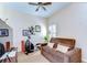 Bedroom with an elliptical machine, a plush sofa and a ceiling fan at 2816 Graphite Ct, Valrico, FL 33594