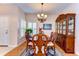 Formal dining room with a wooden table and chairs, complemented by a large china cabinet and bright lighting at 2816 Graphite Ct, Valrico, FL 33594