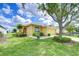 Charming single-Gathering home with a manicured lawn, mature trees, and a welcoming front entrance at 2816 Graphite Ct, Valrico, FL 33594