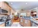 Well-lit kitchen with stainless steel appliances and an eat-in breakfast bar, offering backyard views at 2816 Graphite Ct, Valrico, FL 33594