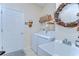 Laundry room with white washer and dryer, a sink, and an American flag themed wreath at 2816 Graphite Ct, Valrico, FL 33594