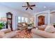 Cozy living room with hardwood floors, grandfather clock, and comfortable seating arrangement at 2816 Graphite Ct, Valrico, FL 33594