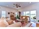 Inviting living room with hardwood floors, ceiling fan, and sliding glass doors to the outdoor space at 2816 Graphite Ct, Valrico, FL 33594