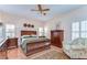 Comfortable bedroom with hardwood floors, ceiling fan, and plantation shutters for natural light at 2816 Graphite Ct, Valrico, FL 33594