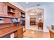 Office space featuring a wooden bookshelf, desk and view into the formal dining room of the home at 2816 Graphite Ct, Valrico, FL 33594