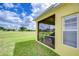 View of screened-in patio overlooking the lush green golf course on a bright, partly cloudy day at 2816 Graphite Ct, Valrico, FL 33594