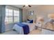 Bright bedroom with blue accents, a cozy bed, and a scenic view from the window at 2967 Gardiner Ln, Zephyrhills, FL 33541