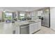 Open-concept kitchen with an island, granite countertops, stainless steel appliances, and views of the dining and living areas at 2967 Gardiner Ln, Zephyrhills, FL 33541