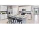 Modern kitchen with island, granite countertops, stainless steel appliances, and breakfast bar seating at 2967 Gardiner Ln, Zephyrhills, FL 33541