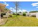 Expansive backyard featuring a pergola-covered patio, manicured lawn, and mature trees at 3360 Masters Dr, Clearwater, FL 33761
