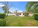 This home has a spacious backyard with lush green grass, perfect for outdoor activities and relaxation at 3360 Masters Dr, Clearwater, FL 33761