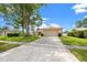 Charming single-story home with a spacious driveway, well-maintained lawn, and mature trees enhancing curb appeal at 3360 Masters Dr, Clearwater, FL 33761