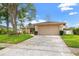Charming single-story home with well-manicured lawn, mature trees, and a spacious two-car garage at 3360 Masters Dr, Clearwater, FL 33761