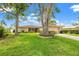 Charming single-story home with well-manicured lawn and mature trees create inviting curb appeal at 3360 Masters Dr, Clearwater, FL 33761