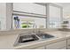 Kitchen sink with a view from the expansive window looking out onto a patio at 3360 Masters Dr, Clearwater, FL 33761
