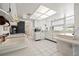 Open-concept kitchen featuring white cabinetry, tile floors, and modern appliances at 3360 Masters Dr, Clearwater, FL 33761