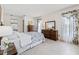 Bright and airy main bedroom with tile floors, classic furnishings, and plenty of natural light at 3360 Masters Dr, Clearwater, FL 33761