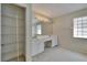 Large bathroom with double vanity and a closet with shelving for extra storage at 3505 Kilmer Dr, Plant City, FL 33566