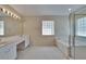 Bright bathroom featuring a glass block window, double vanity, and separate shower at 3505 Kilmer Dr, Plant City, FL 33566