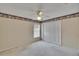 Neutral bedroom with ceiling fan and double closet, decorated with a whimsical character wallpaper border at 3505 Kilmer Dr, Plant City, FL 33566