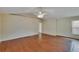 Spacious bedroom with hardwood floors, ceiling fan, and natural light at 3505 Kilmer Dr, Plant City, FL 33566