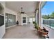 Large covered patio with ceiling fan, tiled flooring and view of back yard at 3505 Kilmer Dr, Plant City, FL 33566