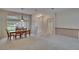 Spacious dining room with natural light, hardwood table and chairs, and neutral carpeting at 3505 Kilmer Dr, Plant City, FL 33566